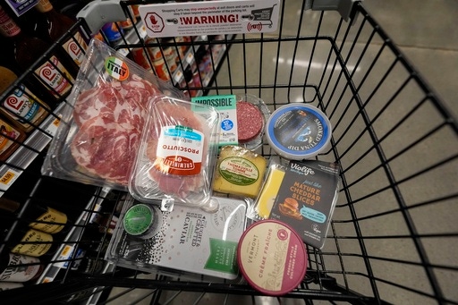 FILE - An assortment of vegan, organic, locally sourced and wild caught food products sit in a shopping cart at a grocery store in New Orleans, Wednesday, April 17, 2024. (AP Photo/Gerald Herbert, File)